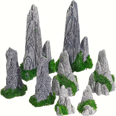 Set of miniature grey mountain rock peak figurines with green moss bases