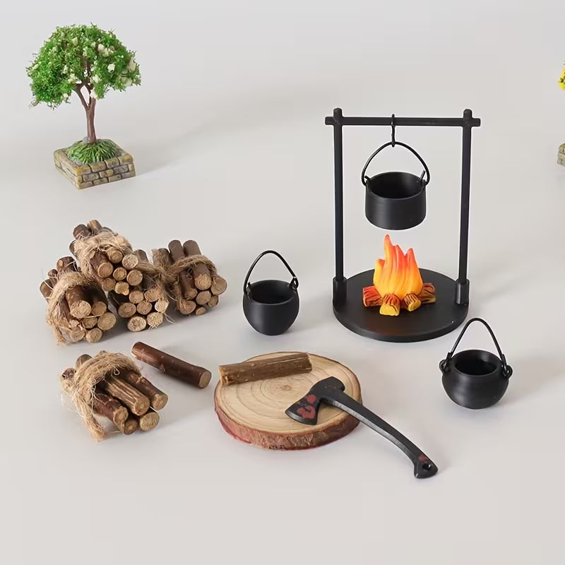 Miniature campfire scene set with cooking tripod, firewood and cauldrons